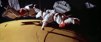 Movie still from “2010: The Year We Make Contact” (1984), directed by Peter Hyams – An image of an astronaut on the surface of the moon; Wide shot, Overhead angle