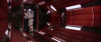 Movie still from “2010: The Year We Make Contact” (1984), directed by Peter Hyams – A person in a spacesuit inside a space ship; Wide shot, Overhead angle