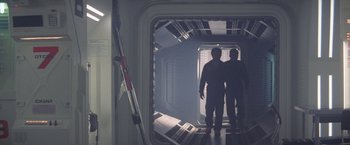 Movie still from “2010: The Year We Make Contact” (1984), directed by Peter Hyams – Two men are standing in an open doorway; Wide shot, Low angle