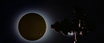Movie still from “2010: The Year We Make Contact” (1984), directed by Peter Hyams – An image of an image of a solar eclipse; Extreme Wide shot, Low angle
