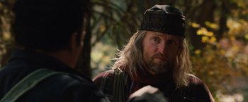 Movie still from “2012” (2009), directed by Roland Emmerich – A person wearing a hat; Close Up shot, Over the shoulder angle