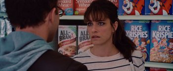 Movie still from “2012” (2009), directed by Roland Emmerich – A woman in striped shirt talking to a man in glasses; Close Up shot, Over the shoulder angle