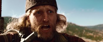 Movie still from “2012” (2009), directed by Roland Emmerich – A person with a beard and a hat on; Close Up shot, Low angle