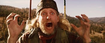 Movie still from “2012” (2009), directed by Roland Emmerich – A person with long hair and a beard; Close Up shot, Low angle