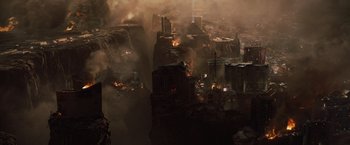 Movie still from “2012” (2009), directed by Roland Emmerich – An aerial view of a city with a lot of smoke; Extreme Wide shot, High angle