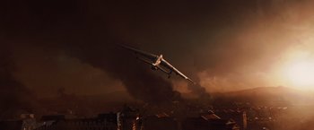 Movie still from “2012” (2009), directed by Roland Emmerich – An airplane is flying through the sky at night; Extreme Wide shot, High angle