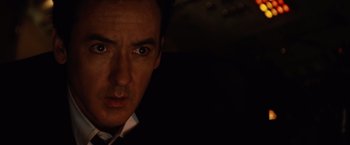 Movie still from “2012” (2009), directed by Roland Emmerich – A man's face in the dark; Close Up shot, Over the shoulder angle