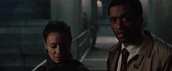 Movie still from “2012” (2009), directed by Roland Emmerich – A man and a woman standing next to each other; Close Up shot, Over the shoulder angle