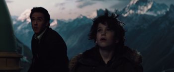 Movie still from “2012” (2009), directed by Roland Emmerich – A young boy is looking up at the sky; Close Up shot, Low angle