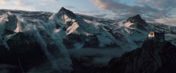 Movie still from “2012” (2009), directed by Roland Emmerich – A large mountain with a cloud filled sky in the background; Extreme Wide shot, Low angle