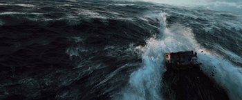 Movie still from “2012” (2009), directed by Roland Emmerich – A house sitting on top of a cliff in the middle of the ocean; Extreme Wide shot, High angle