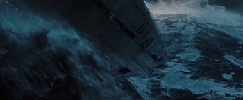 Movie still from “2012” (2009), directed by Roland Emmerich – An image of an airplane flying in the sky above the ocean; Extreme Wide shot, Overhead angle