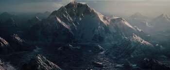 Movie still from “2012” (2009), directed by Roland Emmerich – A mountain with a body of water in the middle of it; Extreme Wide shot, High angle