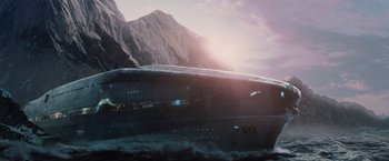 Movie still from “2012” (2009), directed by Roland Emmerich – A boat in the water with a mountain in the background; Extreme Wide shot, Low angle