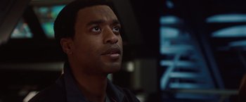 Movie still from “2012” (2009), directed by Roland Emmerich – A person looking up at something; Close Up shot, Over the shoulder angle