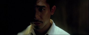Movie still from “2046” (2004), directed by Kar-Wai Wong – A person wearing a white shirt; Close Up shot, High angle