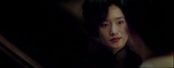 Movie still from “2046” (2004), directed by Kar-Wai Wong – A person wearing a black jacket; Close Up shot, Over the shoulder angle