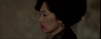 Movie still from “2046” (2004), directed by Kar-Wai Wong – A person wearing a black shirt; Close Up shot, High angle