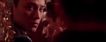 Movie still from “2046” (2004), directed by Kar-Wai Wong – Two men looking into each other's eyes in a dark room; Close Up shot, Low angle