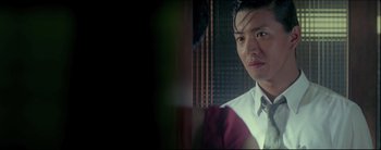 Movie still from “2046” (2004), directed by Kar-Wai Wong – A person wearing a shirt and tie; Close Up shot, Over the shoulder angle