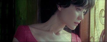 Movie still from “2046” (2004), directed by Kar-Wai Wong – A woman's neck and shoulders; Close Up shot, Low angle