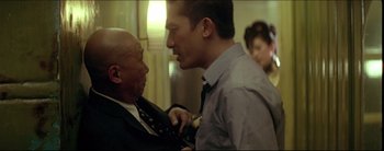 Movie still from “2046” (2004), directed by Kar-Wai Wong – A man in a suit and a man in a dress shirt; Close Up shot, Over the shoulder angle
