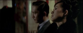 Movie still from “2046” (2004), directed by Kar-Wai Wong – A man and a woman standing next to each other; Close Up shot, Low angle