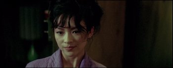 Movie still from “2046” (2004), directed by Kar-Wai Wong – A person wearing a purple shirt; Close Up shot, Over the shoulder angle