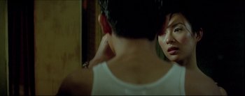 Movie still from “2046” (2004), directed by Kar-Wai Wong – A woman looking at her reflection in a mirror; Close Up shot, Over the shoulder angle