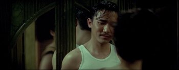 Movie still from “2046” (2004), directed by Kar-Wai Wong – A person wearing a tank top; Close Up shot, Over the shoulder angle