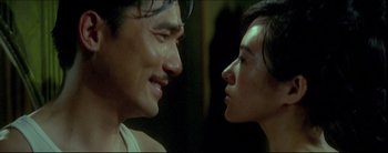 Movie still from “2046” (2004), directed by Kar-Wai Wong – A man and a woman looking at each other; Close Up shot, Over the shoulder angle