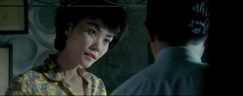 Movie still from “2046” (2004), directed by Kar-Wai Wong – A woman standing next to a man in a room; Close Up shot, Over the shoulder angle