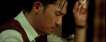 Movie still from “2046” (2004), directed by Kar-Wai Wong – A person wearing a suit and tie; Close Up shot, Low angle