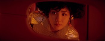 Movie still from “2046” (2004), directed by Kar-Wai Wong – A young woman is looking at the camera through a mirror; Close Up shot, Overhead angle