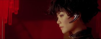Movie still from “2046” (2004), directed by Kar-Wai Wong – A person wearing a black and white outfit; Close Up shot, Low angle