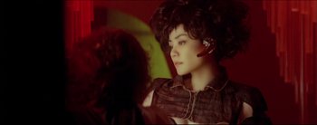 Movie still from “2046” (2004), directed by Kar-Wai Wong – A woman with a cell phone in her ear; Close Up shot, Over the shoulder angle