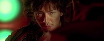 Movie still from “2046” (2004), directed by Kar-Wai Wong – A man's face in the dark; Extreme Close Up shot, Low angle