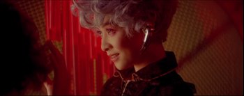 Movie still from “2046” (2004), directed by Kar-Wai Wong – A woman with a silver earring is looking at the camera; Close Up shot, Over the shoulder angle