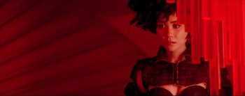 Movie still from “2046” (2004), directed by Kar-Wai Wong – A woman in a black dress and a red background; Close Up shot, Low angle