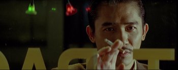 Movie still from “2046” (2004), directed by Kar-Wai Wong – A person smoking a cigarette; Close Up shot, Low angle