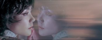 Movie still from “2046” (2004), directed by Kar-Wai Wong – A woman is looking at the camera through a window; Extreme Close Up shot, High angle