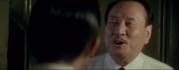 Movie still from “2046” (2004), directed by Kar-Wai Wong – An older man in a white dress shirt and tie talking to a younger man in a black tie; Close Up shot, Over the shoulder angle