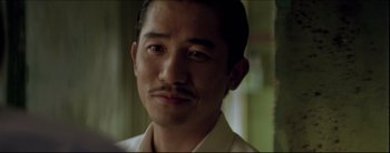 Movie still from “2046” (2004), directed by Kar-Wai Wong – A person with a mustache; Close Up shot, Over the shoulder angle