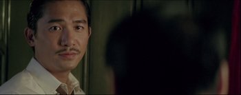 Movie still from “2046” (2004), directed by Kar-Wai Wong – A person with a mustache; Close Up shot, Over the shoulder angle