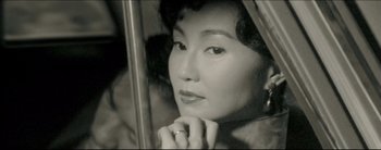 Movie still from “2046” (2004), directed by Kar-Wai Wong – An old photo of an asian woman looking at a mirror; Close Up shot, High angle