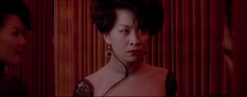 Movie still from “2046” (2004), directed by Kar-Wai Wong – A woman in a black and white dress with a black cord around her neck; Close Up shot, Low angle