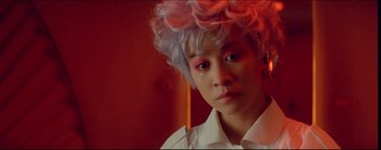 Movie still from “2046” (2004), directed by Kar-Wai Wong – A young man with pink and white hair; Close Up shot, High angle