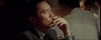 Movie still from “2046” (2004), directed by Kar-Wai Wong – A person smoking a cigarette; Close Up shot, High angle