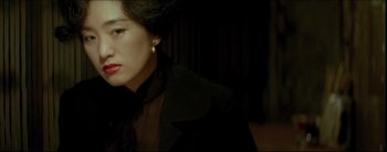 Movie still from “2046” (2004), directed by Kar-Wai Wong – A person wearing a suit and tie; Close Up shot, High angle