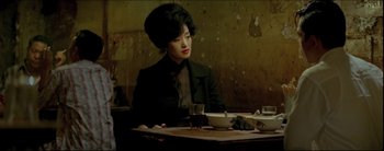 Movie still from “2046” (2004), directed by Kar-Wai Wong – A woman sitting at a table with a bowl of soup; Medium shot, Over the shoulder angle